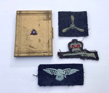 WW2 ROYAL CANADIAN AIR FORCE BRASS CIGARETTE CASE WITH ACCOMPANYING CLOTH BADGES