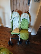 childs double buggy with rain