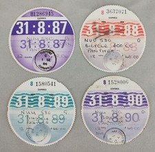 FOUR MOTORCYCLE TAX DISCS /