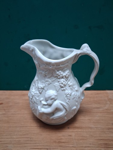 Parian ware embossed jug - a,