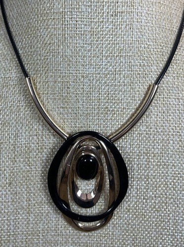 Black gold tone large oval - &,