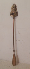 A vintage brass shoe horn