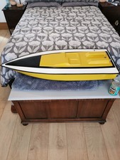 Fibreglass model speedboat hull: yellow; 39 inches long.