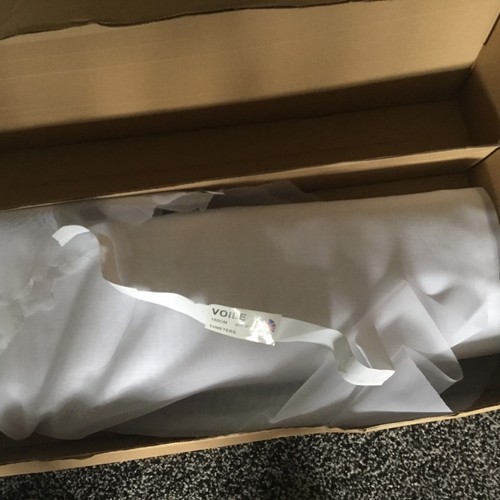 White voile roll partly used - roll.,