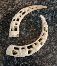 VINTAGE PAIR OF CARVED WARTHOG TUSKS, DETAILED CARVING OF TRAILING ELEPHANTS.