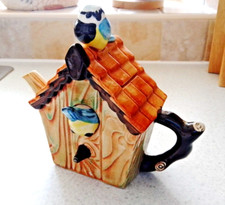 The Teapottery tea pot.England. Lovely teapot blue tits exploring a nesting box.