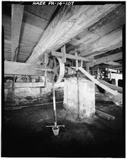 107. BASEMENT, DRIVE SHAFT THAT RUNS JOINTER IN BENCH SHOP. BELT ON RIGHT