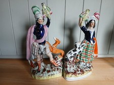 Pair of antique 19th Century flatback  staffordshire pottery figures, with dogs