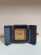 A SMALL ANTIQUE ALARM CLOCK +