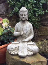 stone garden Buddha meditating