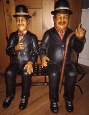 Laurel and Hardy With Walking Stick On Original Metal Bench