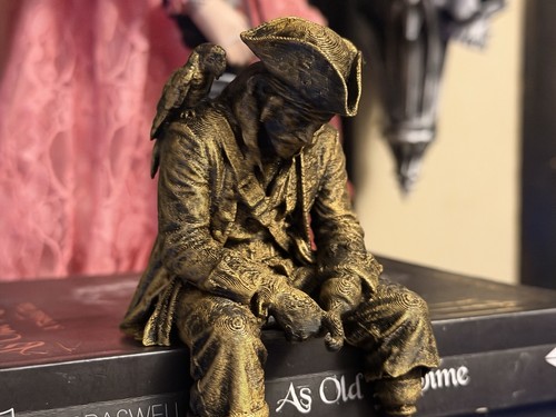 Sad pirate sitting - a, ledge