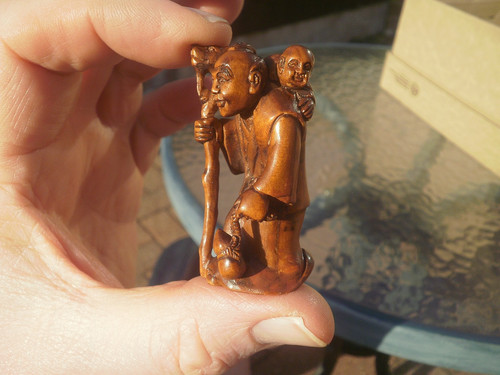 Hand carved wood netsuke man - hand,