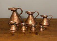 Set of  7 graduated Georgian copper measuring jugs
