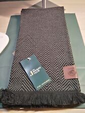 RANDOX GRAND NATIONAL HERRINGBONE DESIGN BLACK AND GREY SCARF WITH TAN LOGO TAB.