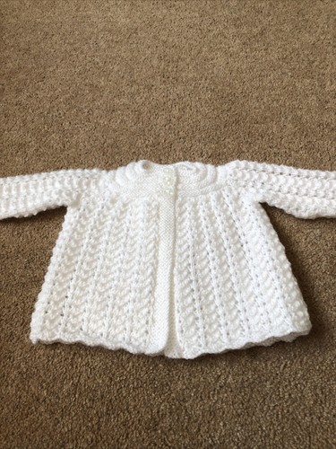 Hand knitted white baby - hand,