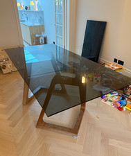 Glass dining table with wooden