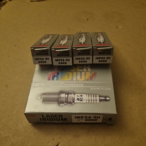 Four ngk spark plugs - ),