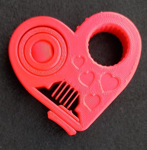 Red heart shaped fidget - shaped, toy