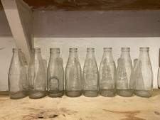 Eight Vintage Milk Bottles