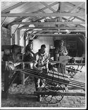 Brickmakers hand-mold bricks using clay from the pug mill on the left Old Photo