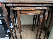 This is a Set of Mahogany flame and inlaid glass topped nest of three tables.