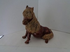 Cheval ceramics seated pony