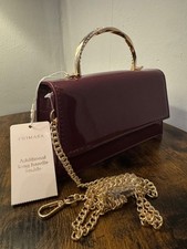 primark burgandy patent clutch bag with golden chain and handle by primark