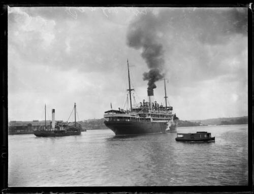 Canberra next to a tug - s.s.,