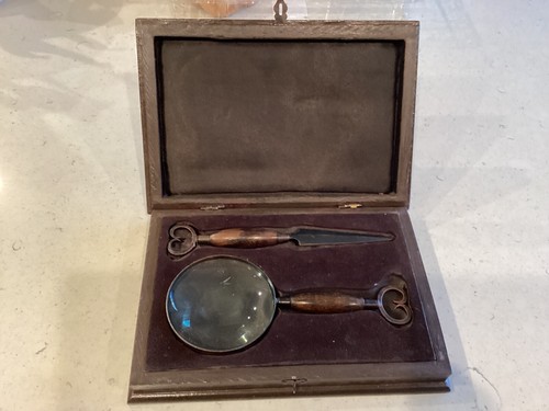 Magnifying glass and - , letter