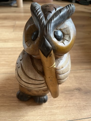 Hand carved wooden owl with - hand,