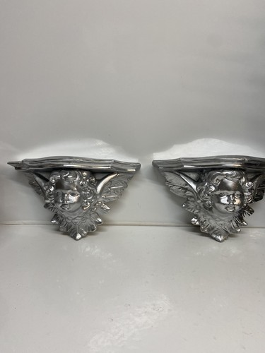 Pair silver resin cherub - of,
