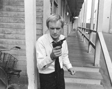 David McCallum holds gun as