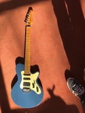 godin electric guitar with a beautiful birds eye maple neck