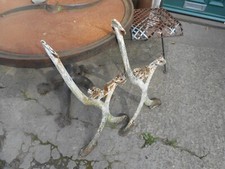 A PAIR OF ANTIQUE CAST IRON GARDEN BENCH ENDS