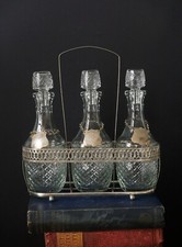 3 BOTTLE CUT GLASS/SILVER PLATED DECANTER SET.1970'S .WHISKEY,SHERRY,PORT.
