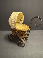 Victorian-style vintage wicker wood baby doll carriage stroller buggy.
