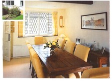 Solid Oak dining room table with eight upholstered chairs preowned