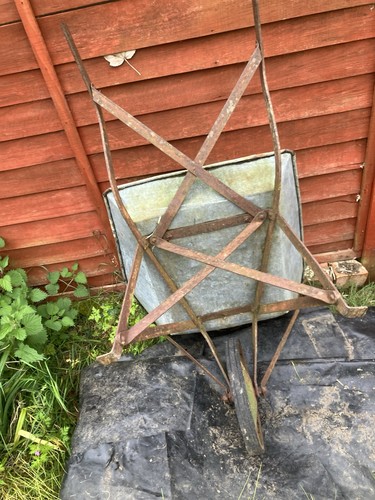 Old metal wheelbarrow - old,