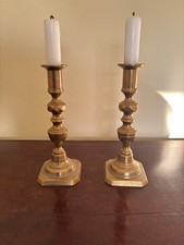 Vintage pair of brass candlestick holders 8" tall and 3" wide at base. 
