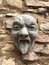 Stone face garden ornament wall hanging gurning statue funny tongue out and down