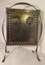 An Arts & Crafts brass & iron fire guard – decorative fireplace screen.