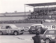 MINI'S & FORD CORTINA MK.1, IN RACE ACTION, PHOTOGRAPH.