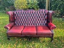 Vintage Oxblood Faux Leather Wing-Back Chesterfield 3 Seater Sofa. Black Legs
