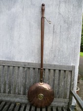 AN ANTIQUE FRENCH WOODEN HANDLED COPPER HOT WATER BOTTLE. COPPER BED WARMING PAN
