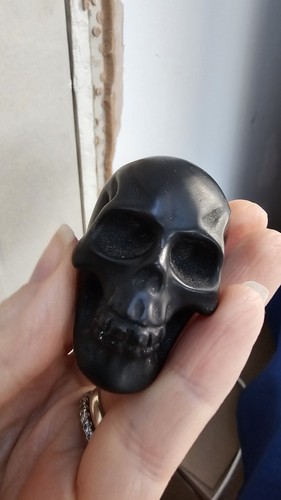 Carved black obsidian skull - black,
