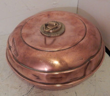 An antique copper hot water bottle