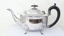 Scalloped Lid Silver Plated Teapot With Four Decorative Feet And Oval Body