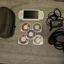 Sony PSP-1003 - White Console  tested. charger included. 4 UMD movies, 1 game