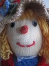 AUTUMNAL HAND KNITTED SALLY SCARECROW FORAGING MUSHROOMS AND PUMPKINS.